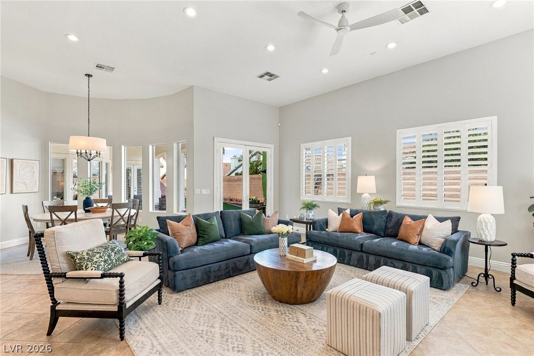 210 Torrey Morgan Way, Henderson, NV 89074 Soaring ceilings and tall windows illuminate a spacious, tile-floored living area perfect for hosting guests.