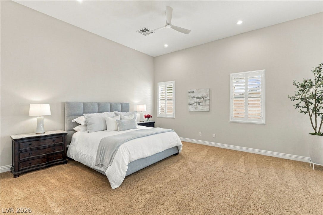 210 Torrey Morgan Way, Henderson, NV 89074 High ceilings and plush carpeting define this airy bedroom retreats architectural character.