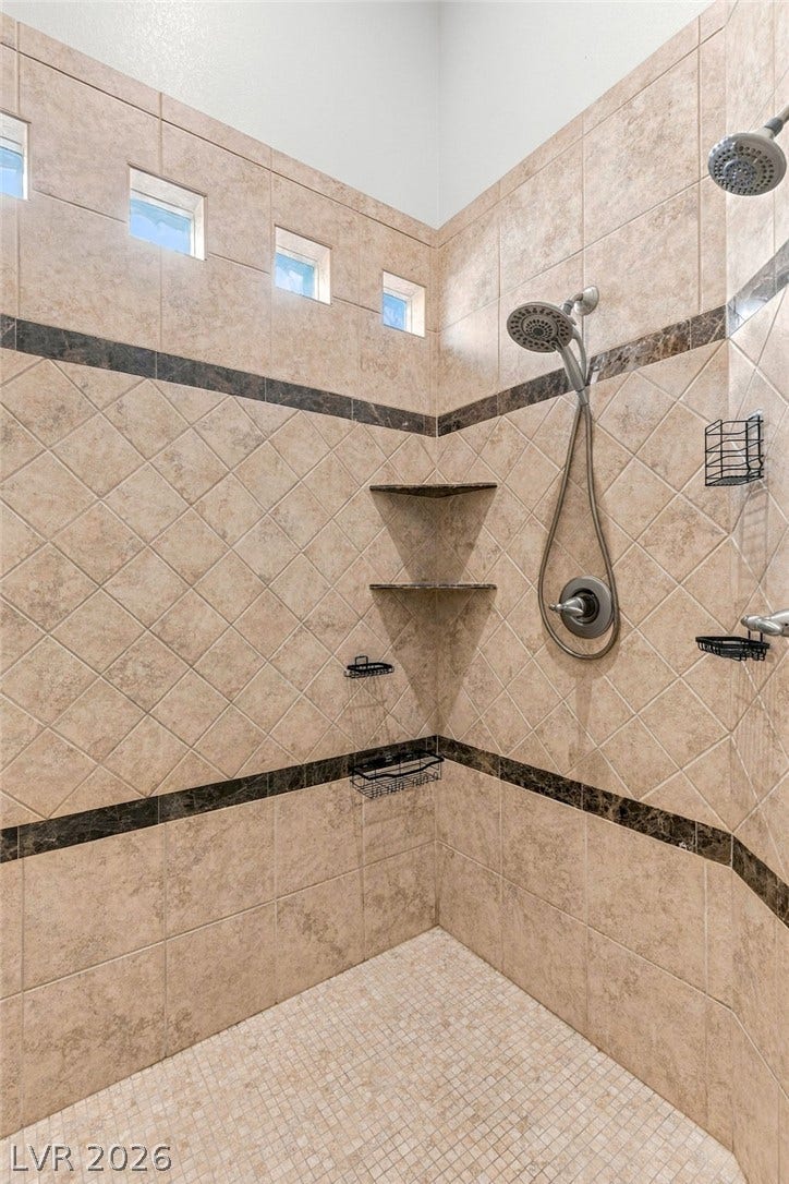 210 Torrey Morgan Way, Henderson, NV 89074 High ceilings and intricate tilework define this spacious walk-in shower with dual showerheads.