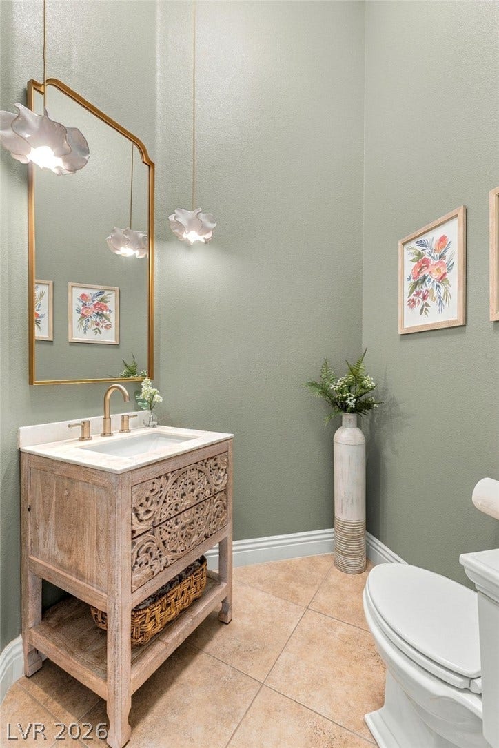 210 Torrey Morgan Way, Henderson, NV 89074 A stylish vanity paired with neutral tile flooring anchors this elegant powder room.