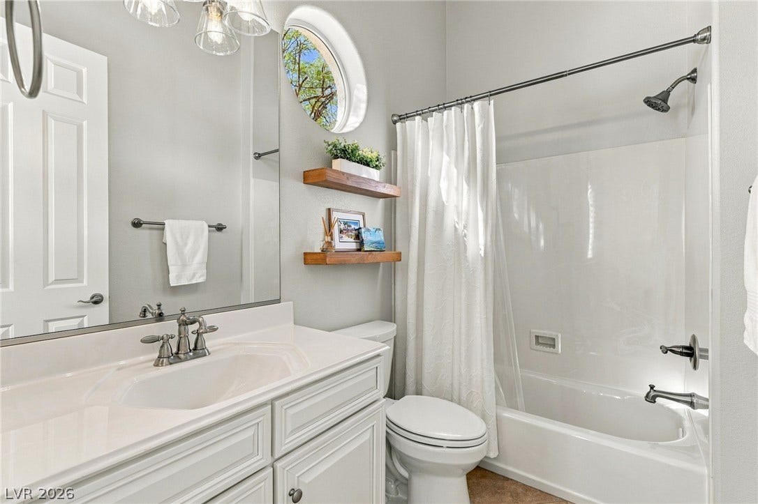 210 Torrey Morgan Way, Henderson, NV 89074 High ceilings and a round window create an airy feeling in this full bathroom.