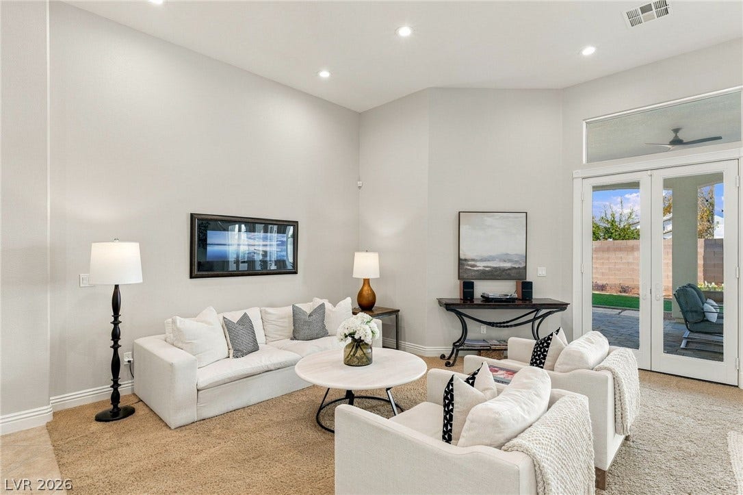 210 Torrey Morgan Way, Henderson, NV 89074 High ceilings and glass doors overlooking the patio elevate this inviting living space.