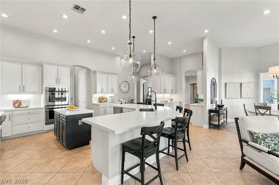 210 Torrey Morgan Way, Henderson, NV 89074 Polished tile flooring and double prep islands anchor this open-concept kitchen.