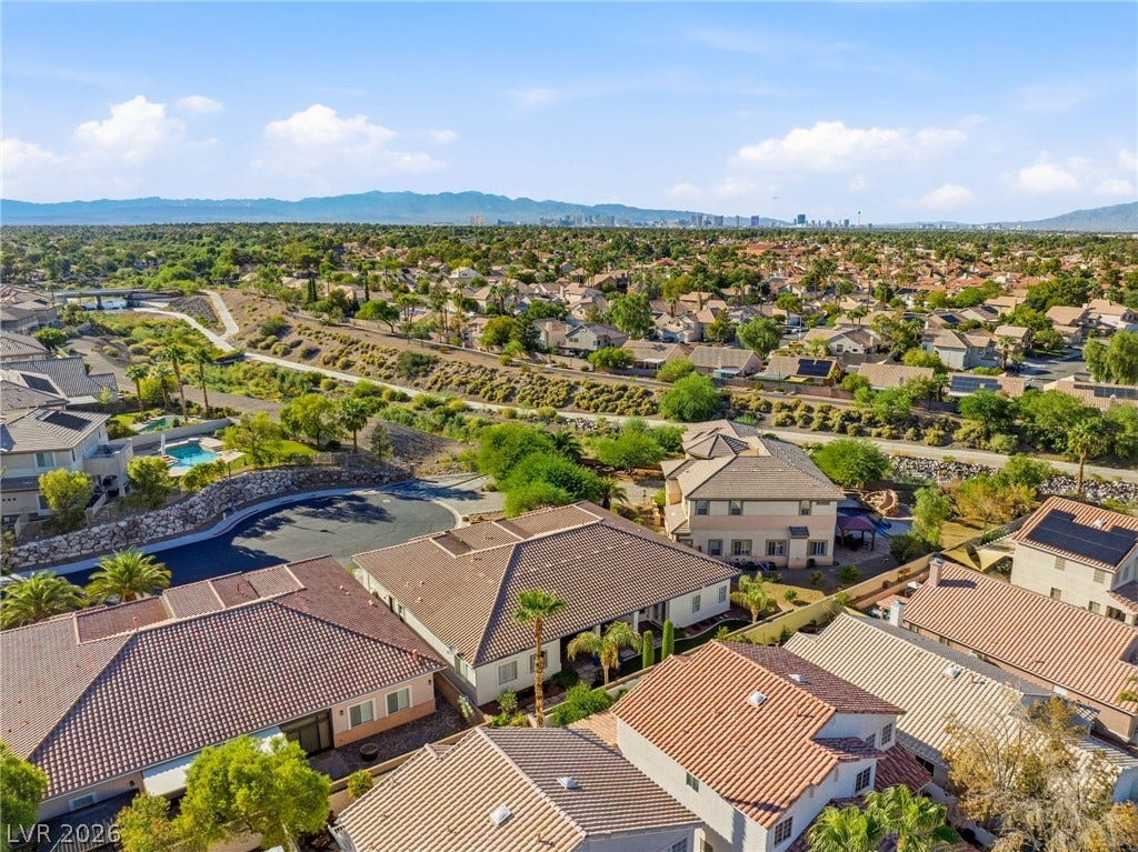210 Torrey Morgan Way, Henderson, NV 89074 Distant city skyline and mountain views elevate this peaceful neighborhood perspective.