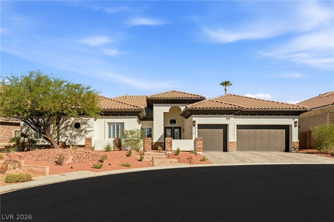 210 Torrey Morgan Way, Henderson, NV 89074 An elegant stucco facade with a tile roof and a spacious three-car garage.