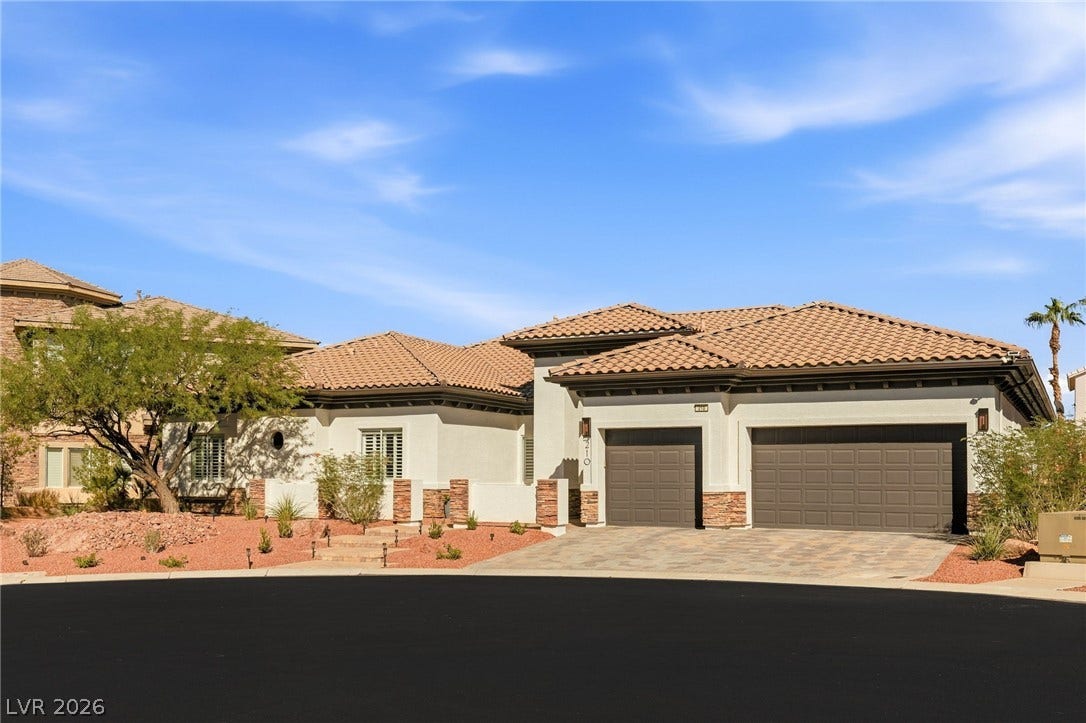 210 Torrey Morgan Way, Henderson, NV 89074 A classic tiled roof and paved driveway elevate the exterior of this single-story home.
