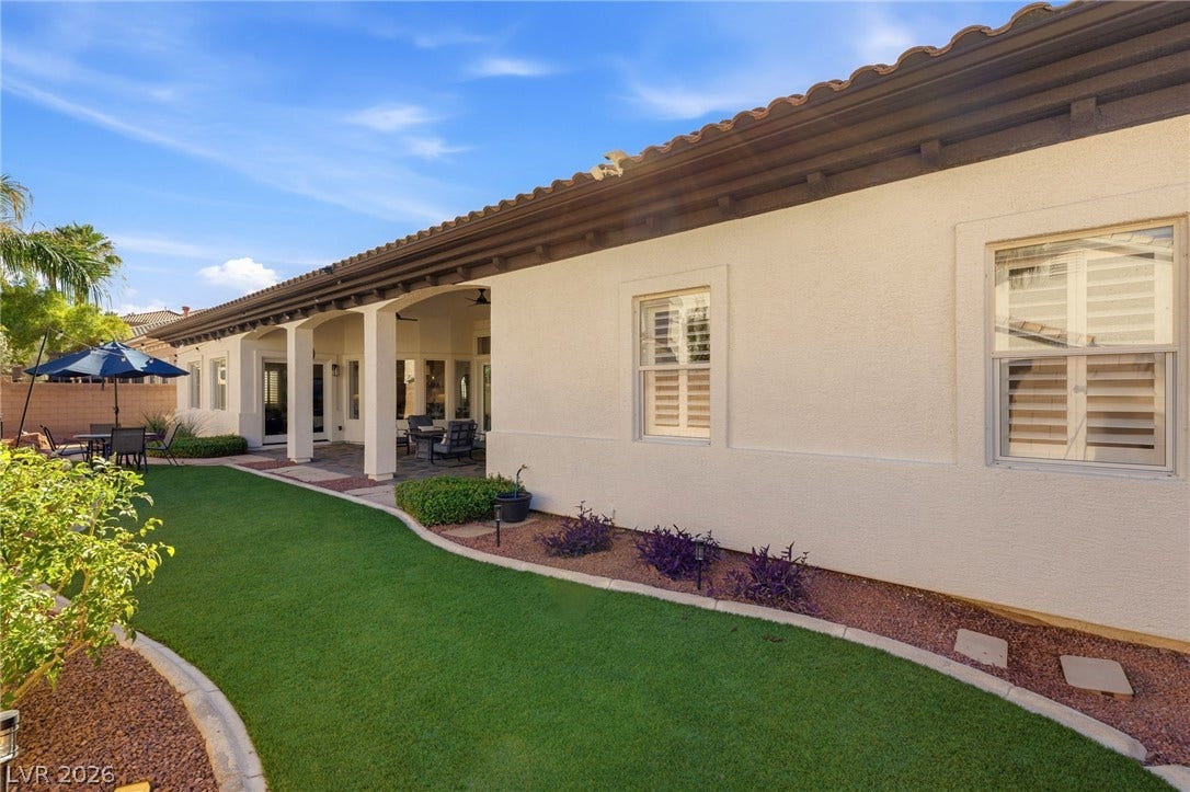 210 Torrey Morgan Way, Henderson, NV 89074 Manicured landscaping complements the classic stucco exterior and tiled roofline of this single-story residence.
