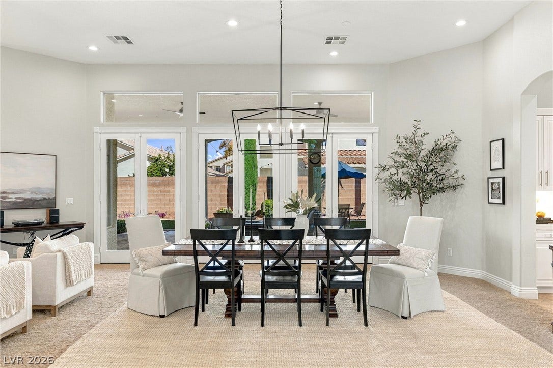 210 Torrey Morgan Way, Henderson, NV 89074 An open dining area showcases high ceilings, recessed lighting, and glass doors to the backyard.
