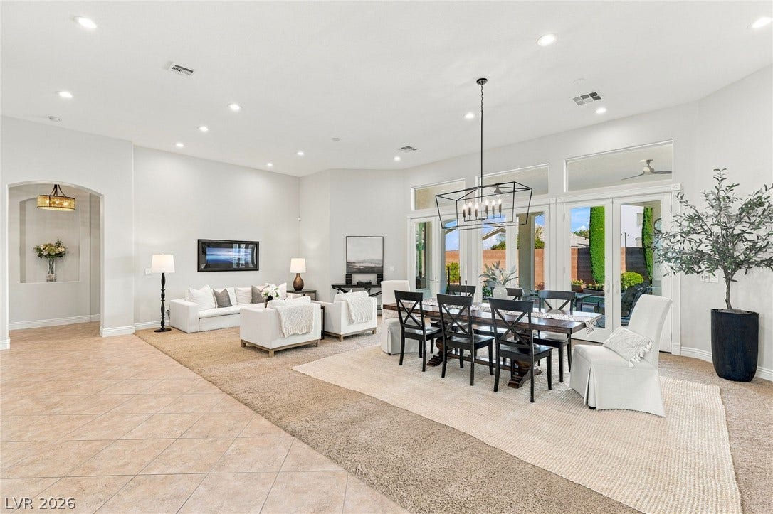 210 Torrey Morgan Way, Henderson, NV 89074 Graceful archways and recessed lighting illuminate this open living and dining area with tile floors.
