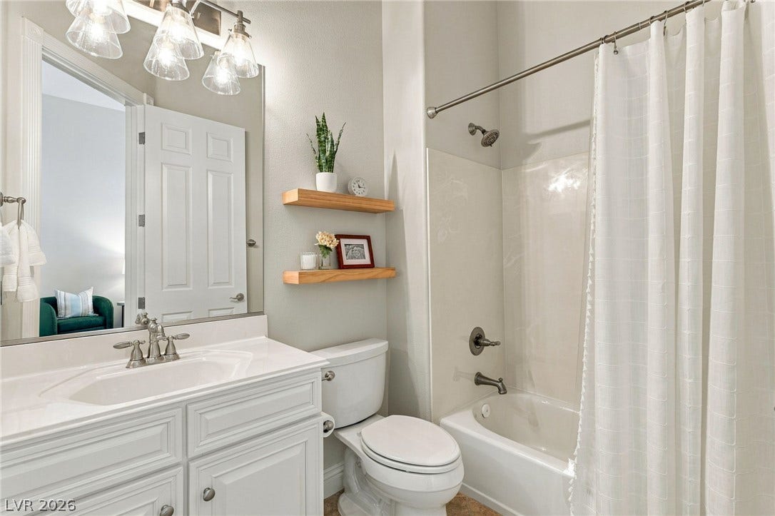 210 Torrey Morgan Way, Henderson, NV 89074 High ceilings and clean finishes define this welcoming secondary bathroom.