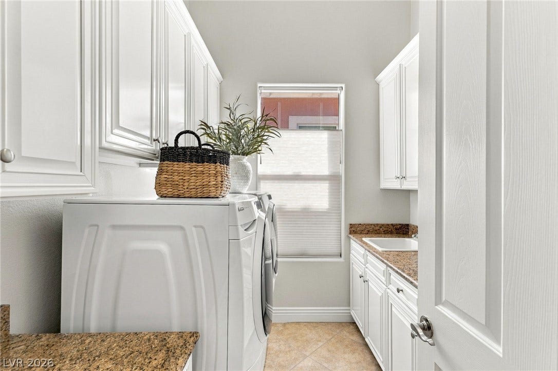 210 Torrey Morgan Way, Henderson, NV 89074 Ample cabinetry and stone countertops elevate this dedicated laundry space.