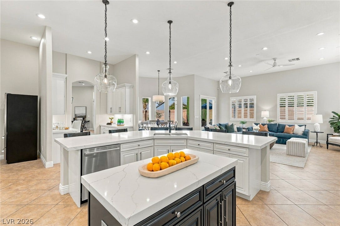 210 Torrey Morgan Way, Henderson, NV 89074 Polished stone countertops and seamless tile flooring anchor this airy open kitchen and living area.