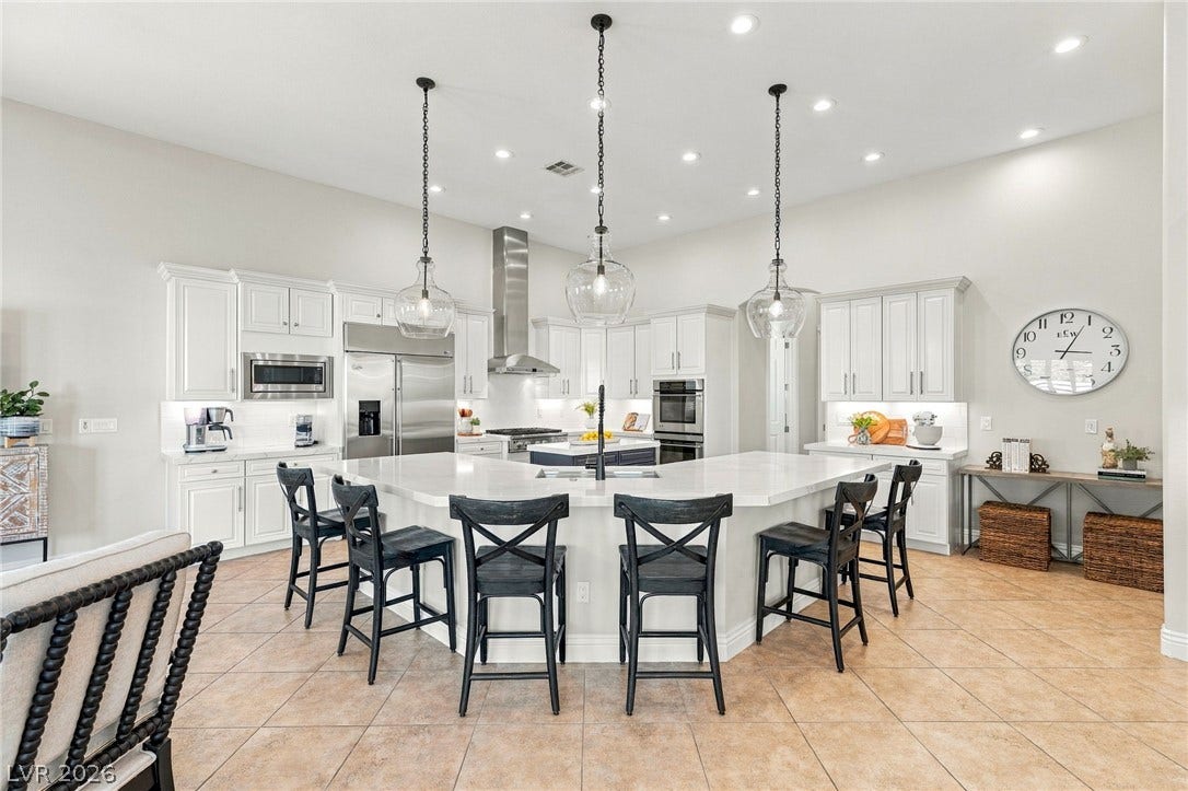 210 Torrey Morgan Way, Henderson, NV 89074 Gleaming tile floors and custom cabinetry anchor this expansively designed workspace.