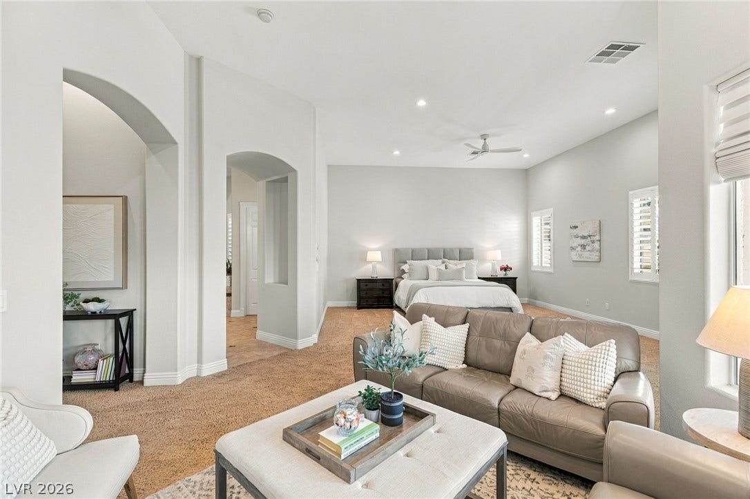 210 Torrey Morgan Way, Henderson, NV 89074 Arched doorways and high ceilings define this spacious bedroom suite with soft carpeting.