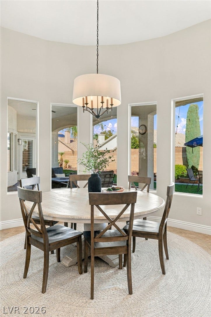 210 Torrey Morgan Way, Henderson, NV 89074 A curved wall of windows illuminates this elegant space featuring soaring high ceilings.
