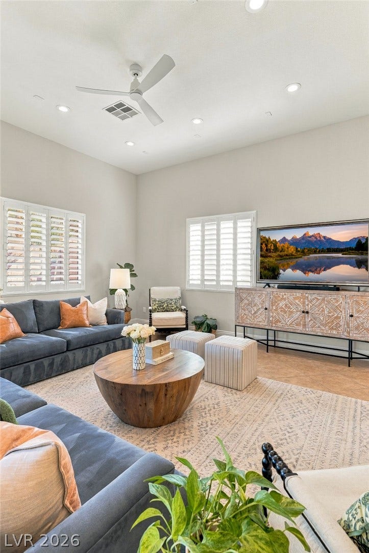 210 Torrey Morgan Way, Henderson, NV 89074 High ceilings and plantation shutters enhance this welcoming living room featuring recessed lighting.