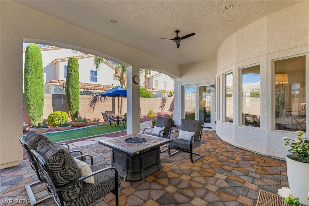 210 Torrey Morgan Way, Henderson, NV 89074 An inviting covered patio featuring patterned pavers overlooks a private landscaped yard.