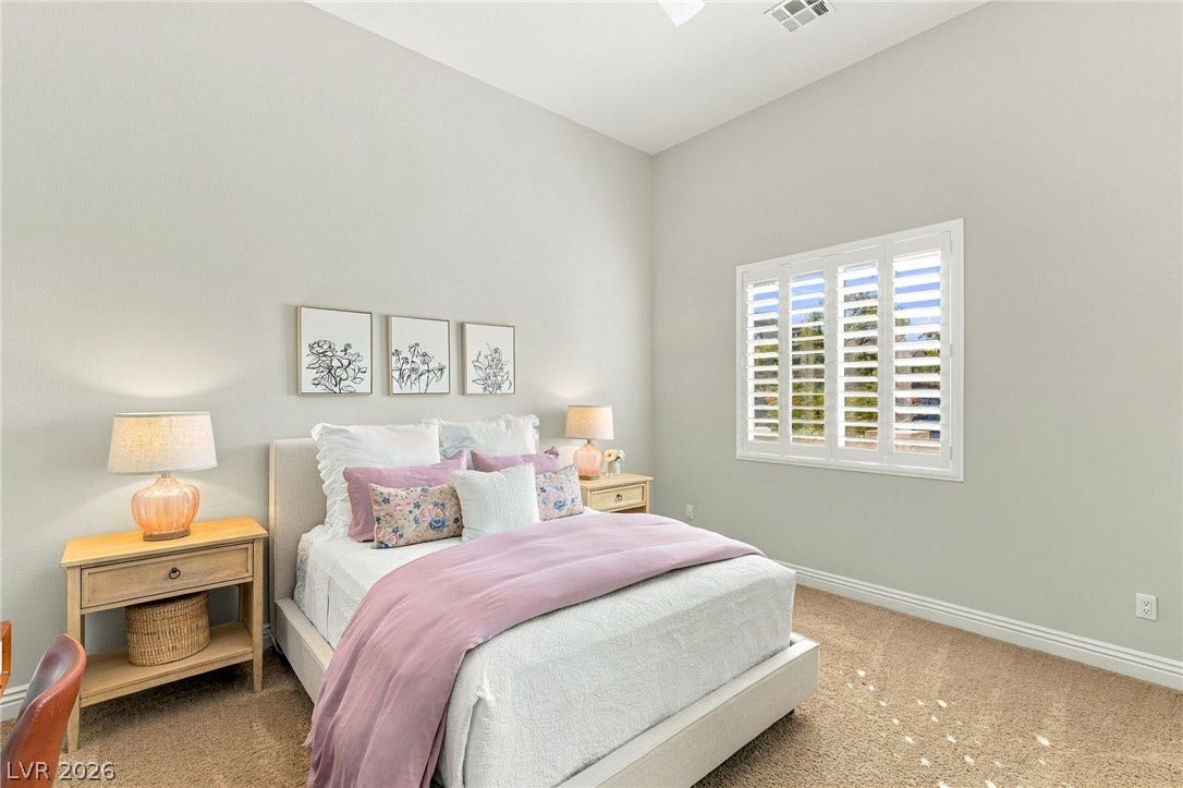 210 Torrey Morgan Way, Henderson, NV 89074 High ceilings and plantation shutters elevate this comfortable bedroom.