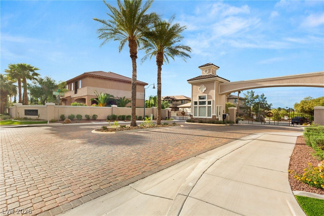210 Torrey Morgan Way, Henderson, NV 89074 An inviting gated entrance features elegant brick paving and tropical palm trees.