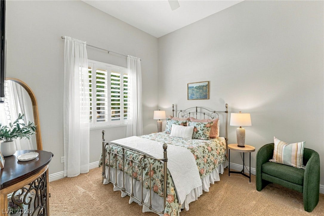210 Torrey Morgan Way, Henderson, NV 89074 Vaulted ceilings and warm carpeting create an inviting atmosphere in this cozy bedroom retreat.