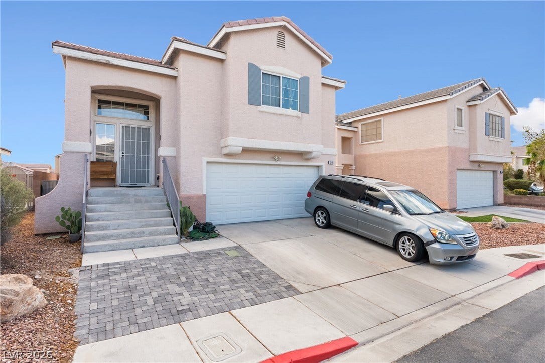 5348 Reardon Court, North Las Vegas, NV 89031 Stately stucco architectural design highlights this multi-level exterior displaying stone accents and a paved driveway.