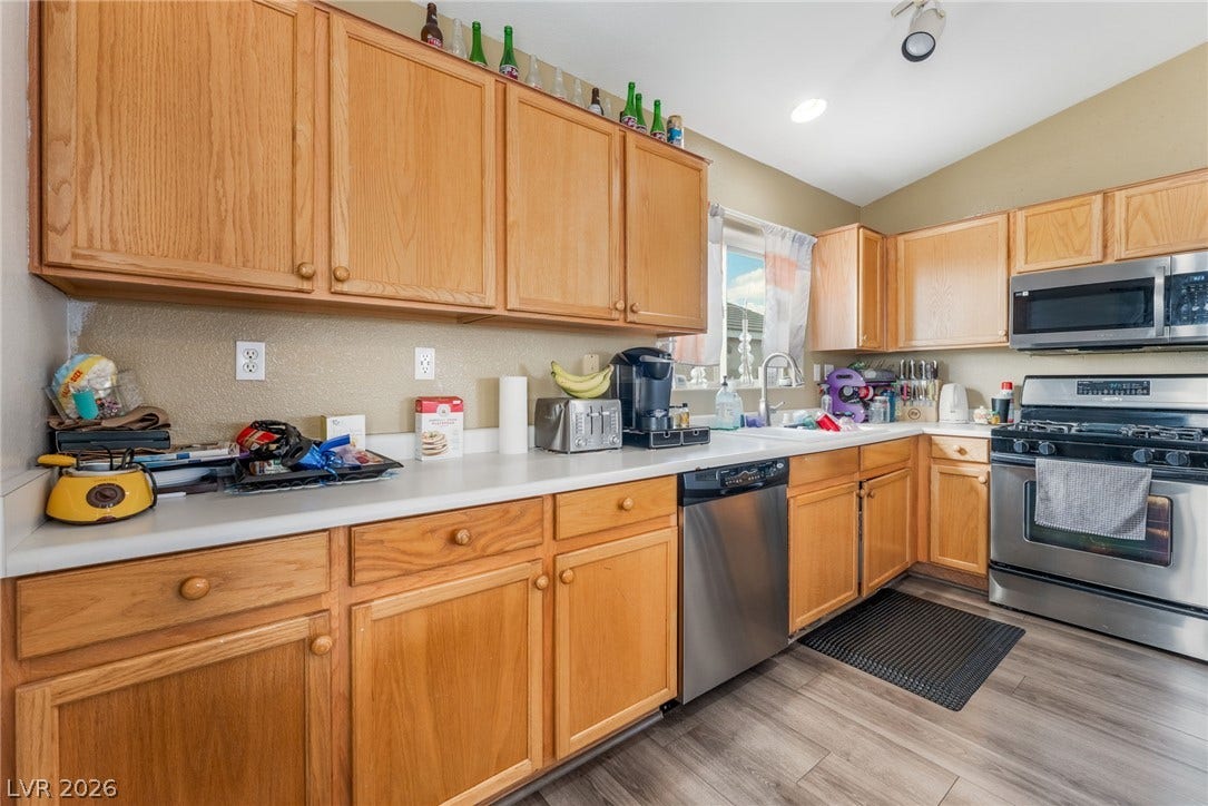 5348 Reardon Court, North Las Vegas, NV 89031 Warm wood cabinetry and modern stainless steel appliances define this functional kitchen space.