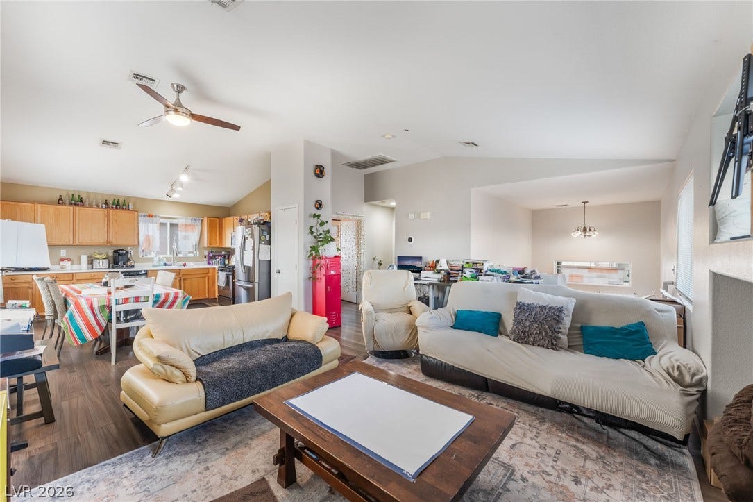 5348 Reardon Court, North Las Vegas, NV 89031 Vaulted ceilings and wood-style flooring sweep through this open-concept main living space.