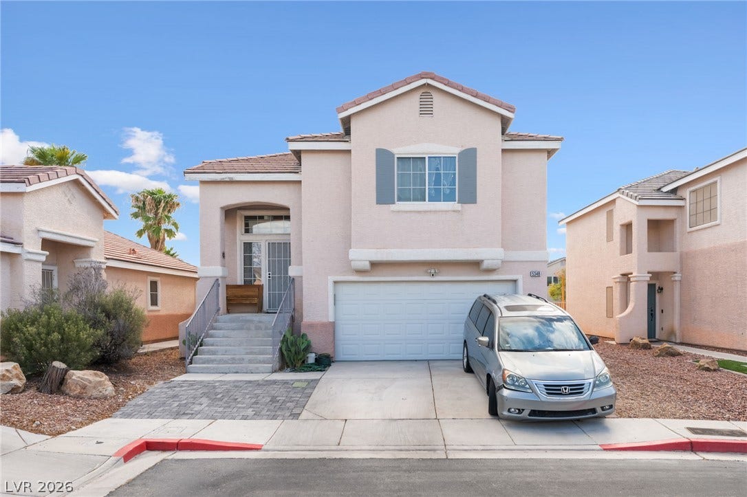 5348 Reardon Court, North Las Vegas, NV 89031 An inviting stucco exterior features steps ascending to a covered entryway beside a two-car garage.