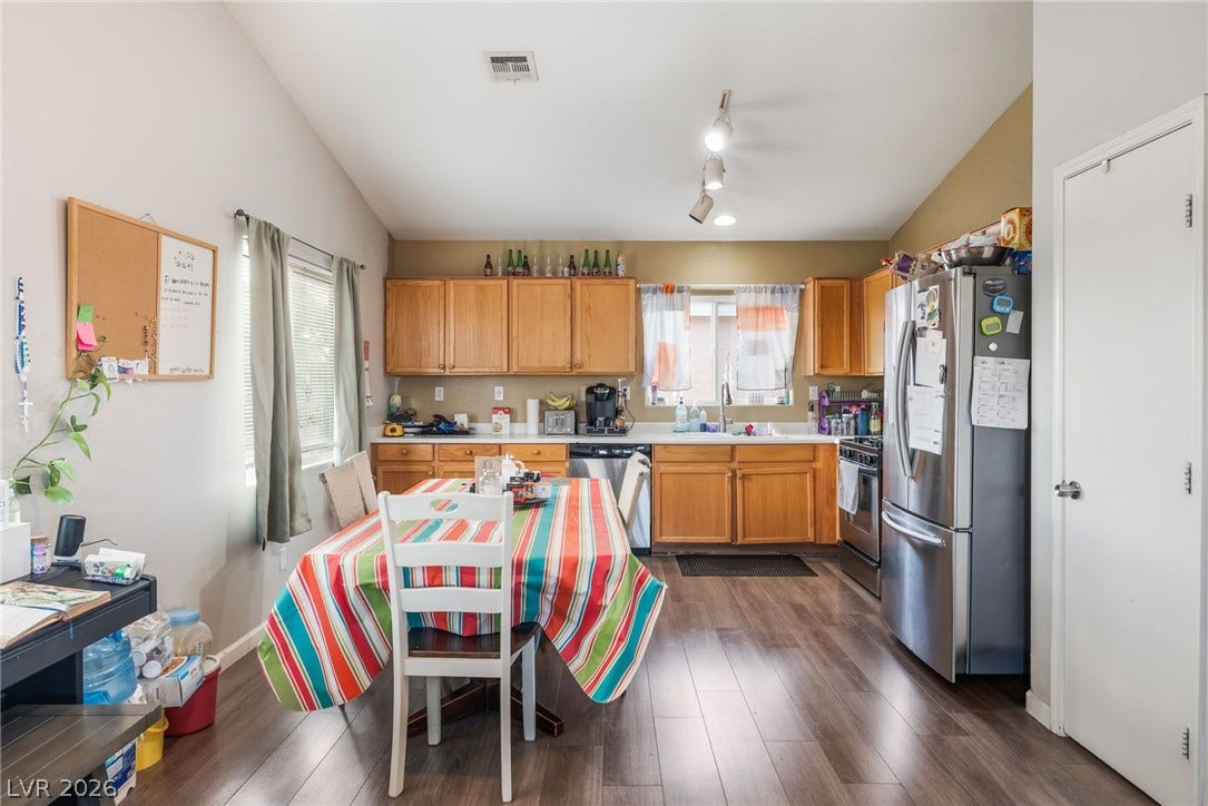 5348 Reardon Court, North Las Vegas, NV 89031 Gleaming wood-inspired floors anchor an airy kitchen equipped with classic oak cabinets and stainless appliances.