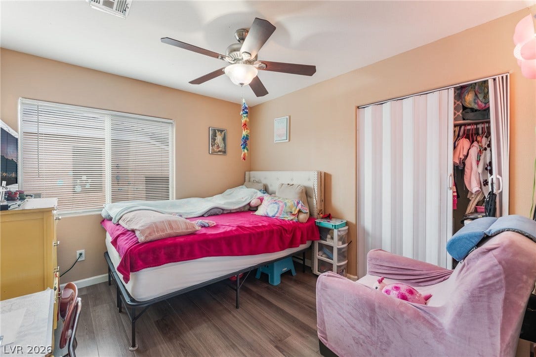 5348 Reardon Court, North Las Vegas, NV 89031 Natural light streams through a wide window onto classic wood-look flooring.
