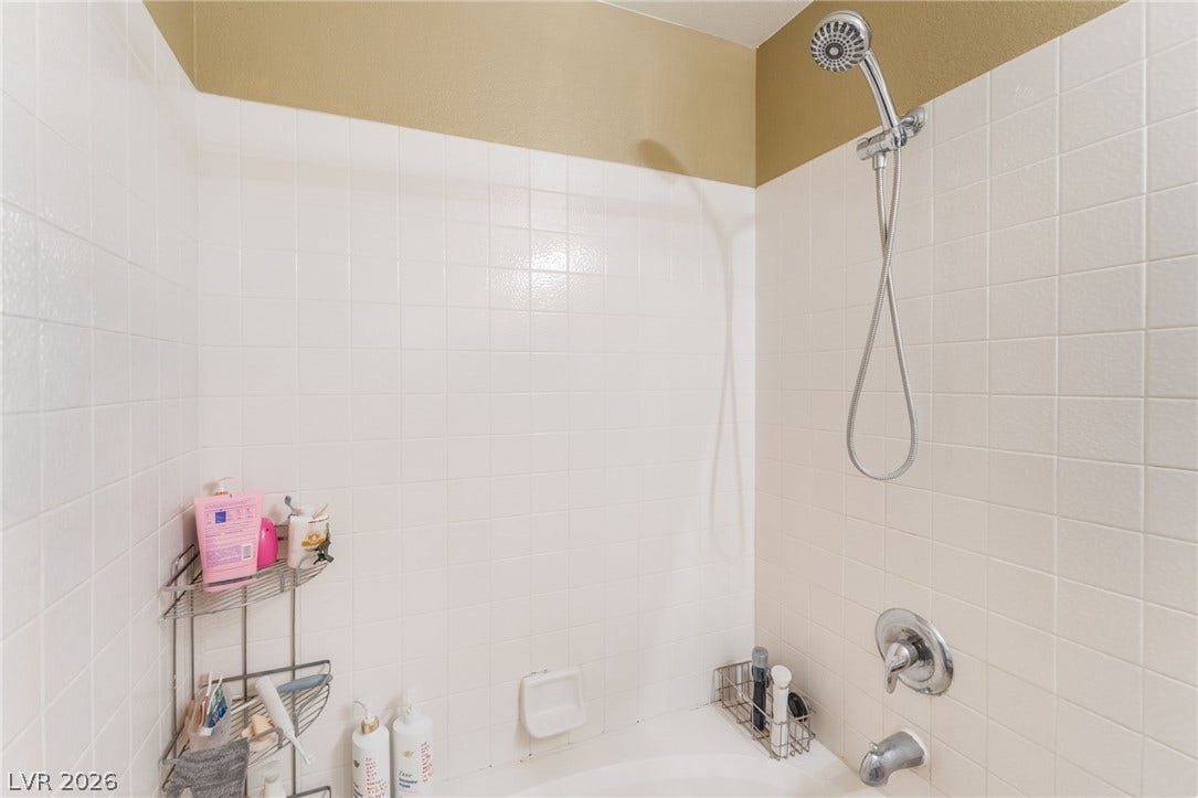 5348 Reardon Court, North Las Vegas, NV 89031 Crisp white wall tile surrounds this functional shower and tub combination.