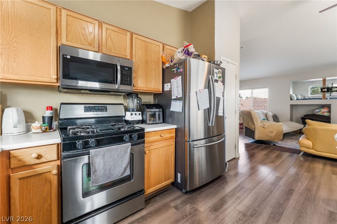 5348 Reardon Court, North Las Vegas, NV 89031 Natural wood cabinetry and stainless steel appliances anchor this open concept kitchen design.