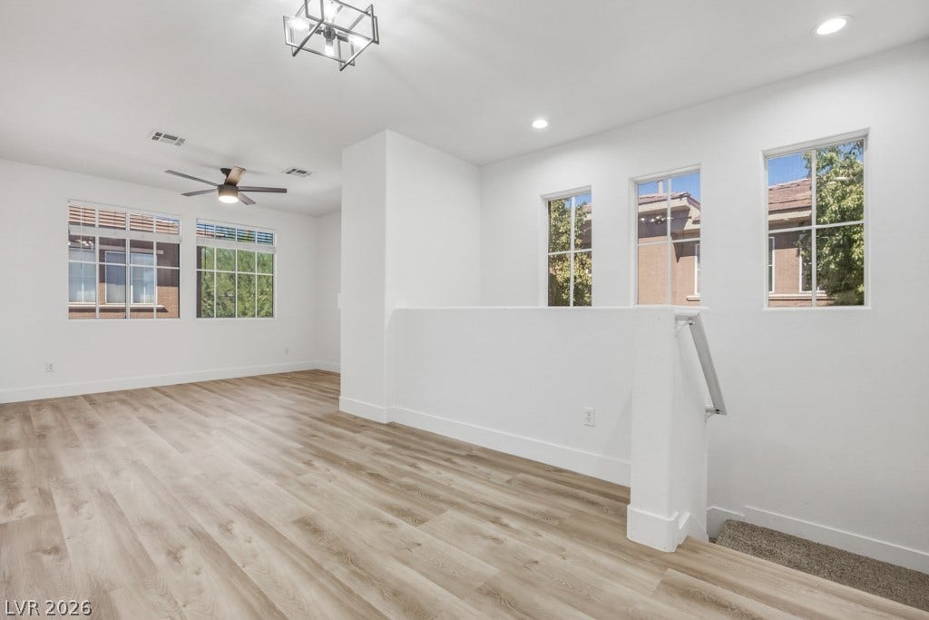Looking toward the Living Room area. Updated Luxury Vinyl Flooring and modern Light Fixtures.
