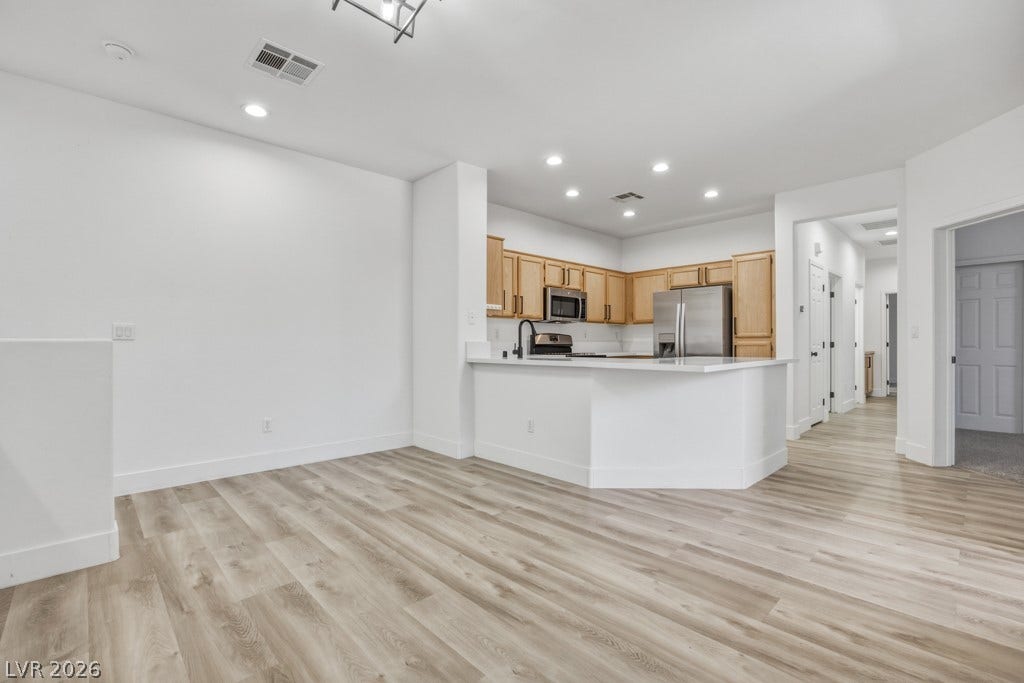 Overview of Dining Area and Open Kitchen from the Living Room area.