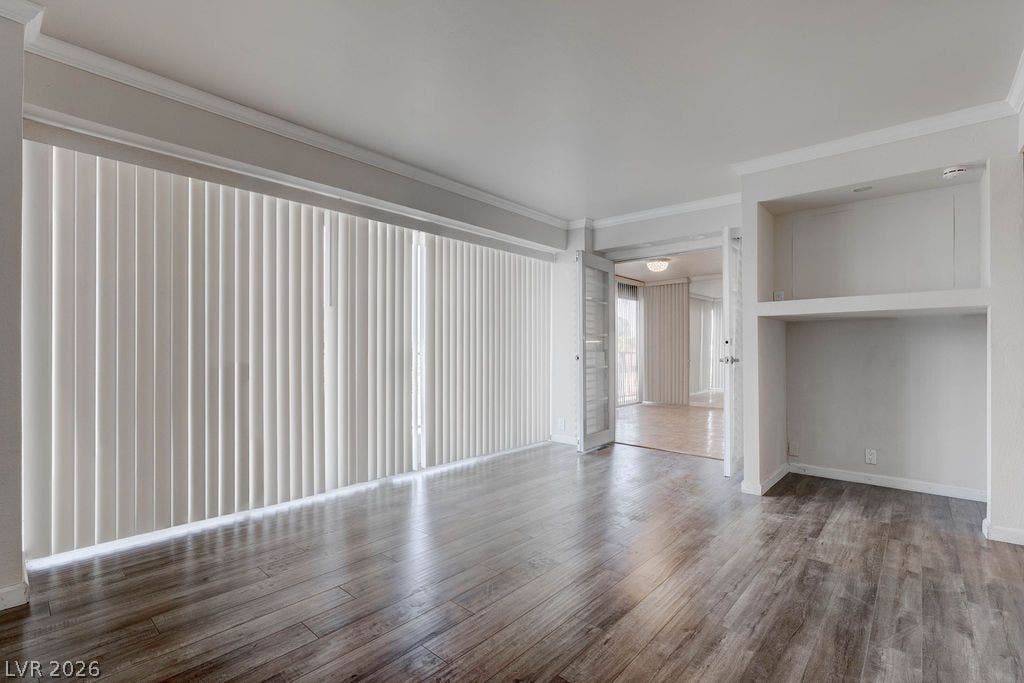 3111 Bel Air Drive, #3A, Las Vegas, NV 89109 Polished wood-style floors and a custom built-in nook anchor this versatile open living space.