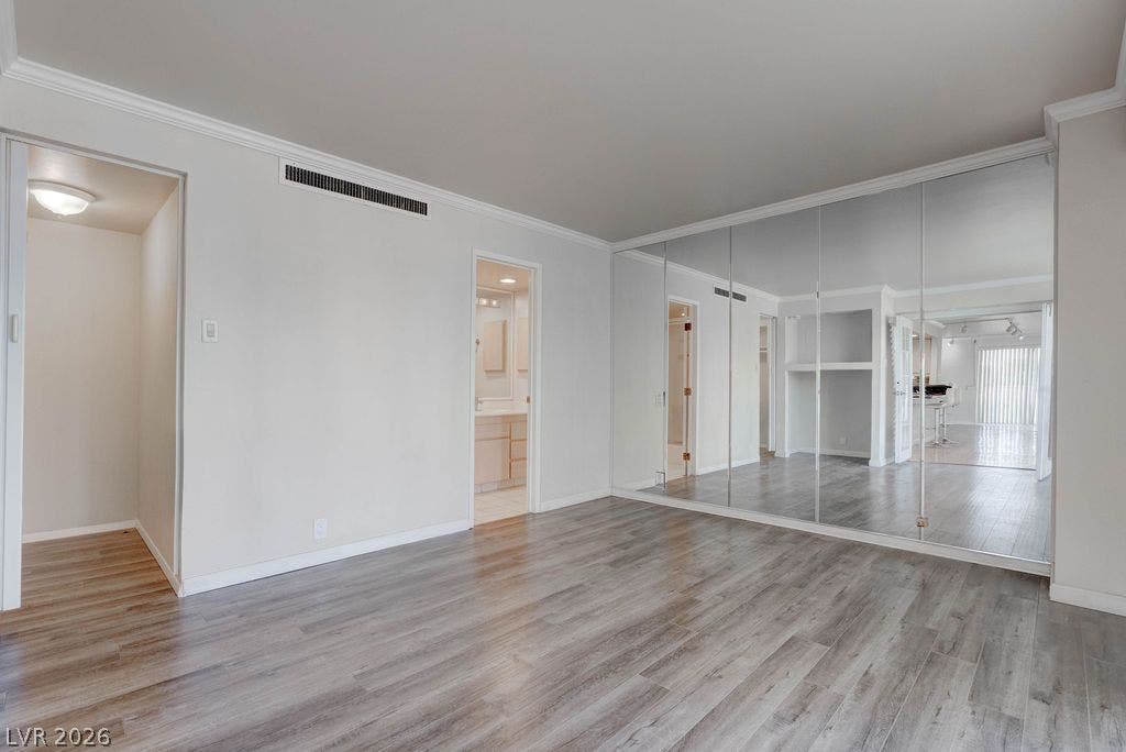 3111 Bel Air Drive, #3A, Las Vegas, NV 89109 Crisp crown molding accents the clean lines and smooth wood-look flooring of this versatile room.