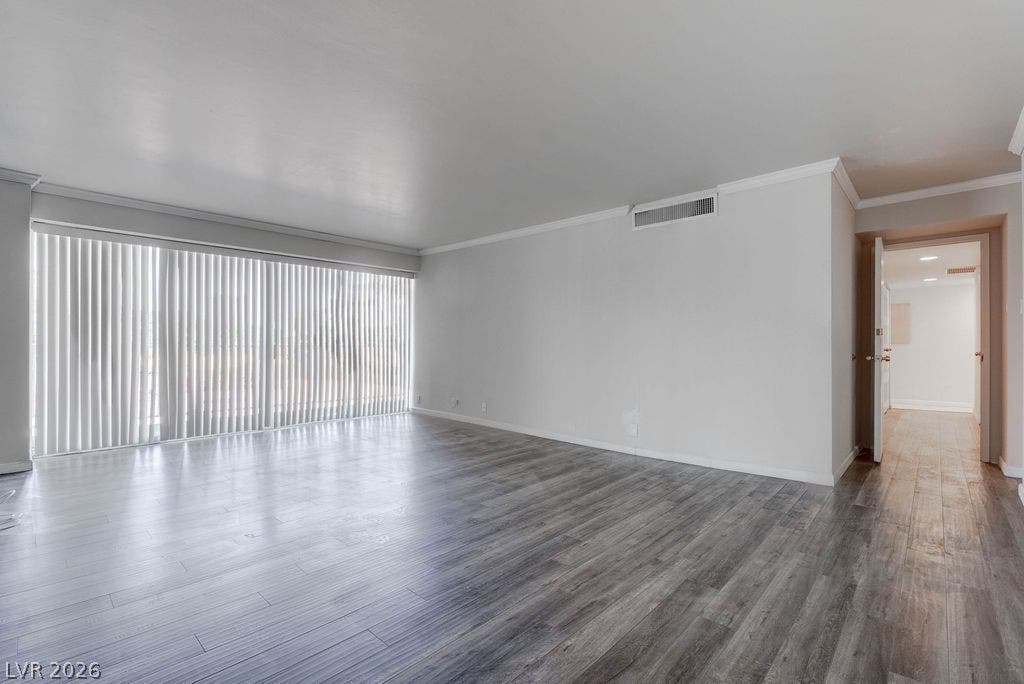 3111 Bel Air Drive, #3A, Las Vegas, NV 89109 Smooth crown molding and handsome wood-patterned flooring define this versatile main living area.