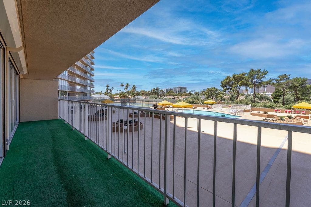3111 Bel Air Drive, #3A, Las Vegas, NV 89109 Sliding glass doors open to a private balcony overlooking a pool and tennis courts.