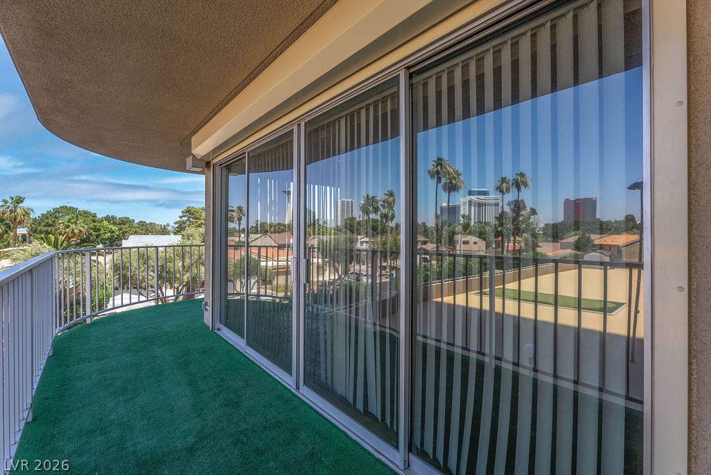 3111 Bel Air Drive, #3A, Las Vegas, NV 89109 A spacious covered balcony with safety railings overlooks the surrounding neighborhood landscape.