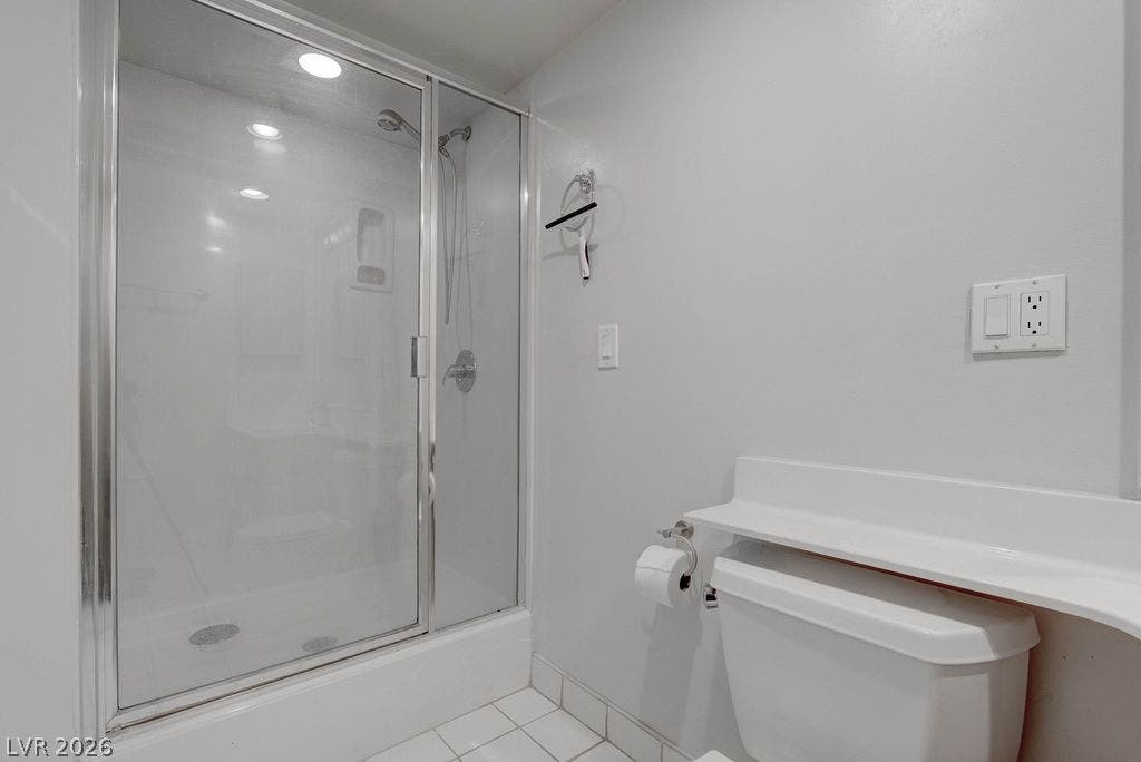 3111 Bel Air Drive, #3A, Las Vegas, NV 89109 A glass-enclosed shower is paired with tiled flooring in this modern bathroom layout.