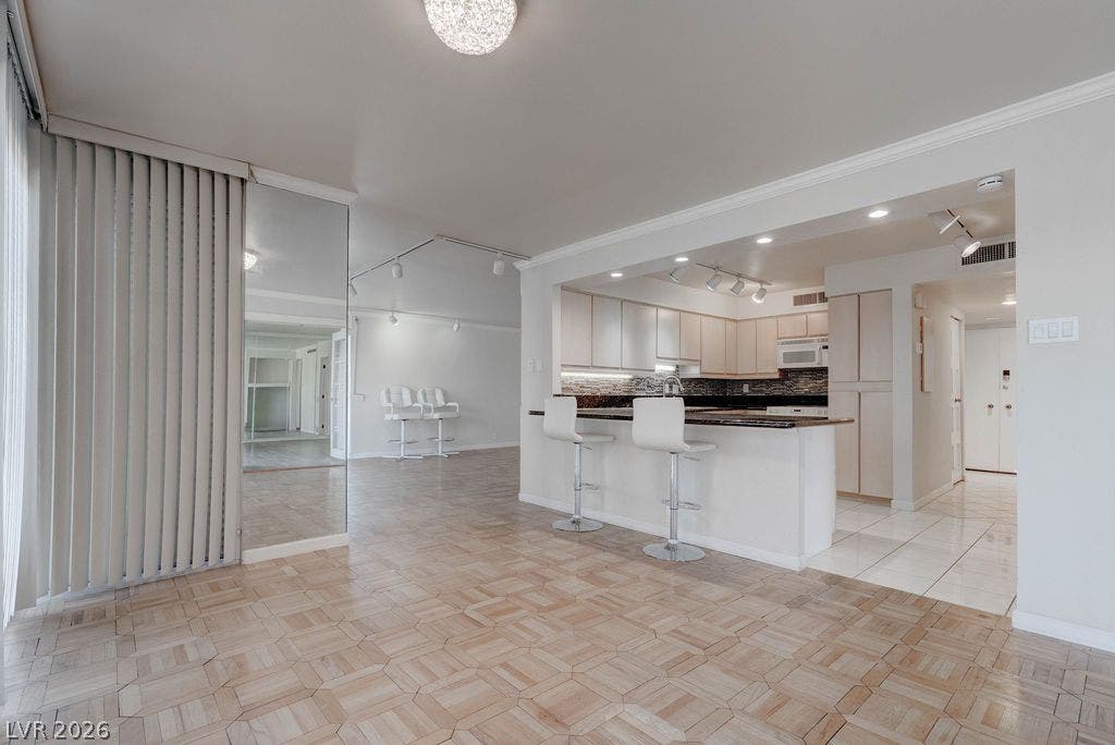 3111 Bel Air Drive, #3A, Las Vegas, NV 89109 An open floor plan seamlessly connects the parquet-floored living area to the kitchen.