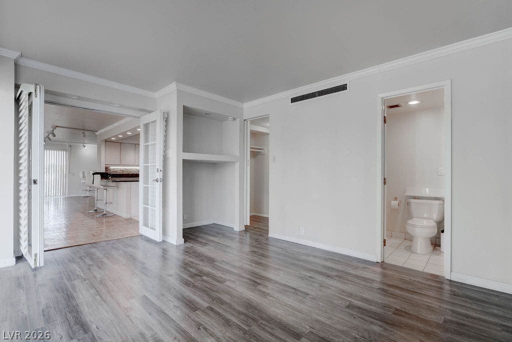 3111 Bel Air Drive, #3A, Las Vegas, NV 89109 Modern wood floors and classic crown molding accent this versatile living space.