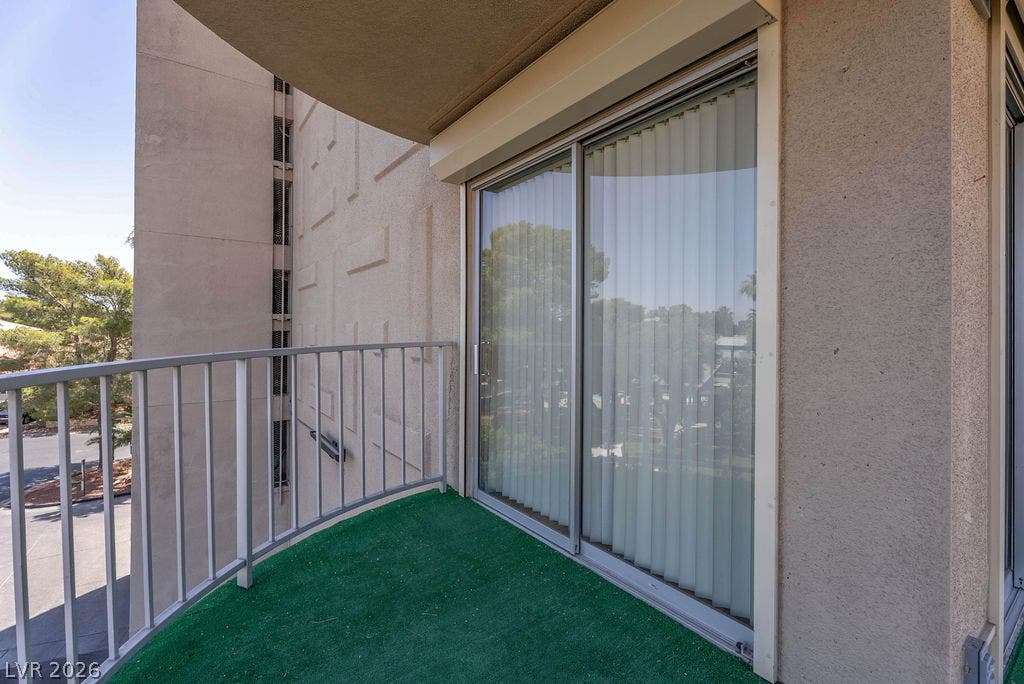 3111 Bel Air Drive, #3A, Las Vegas, NV 89109 Sliding glass doors open onto a private outdoor terrace with concrete structures.