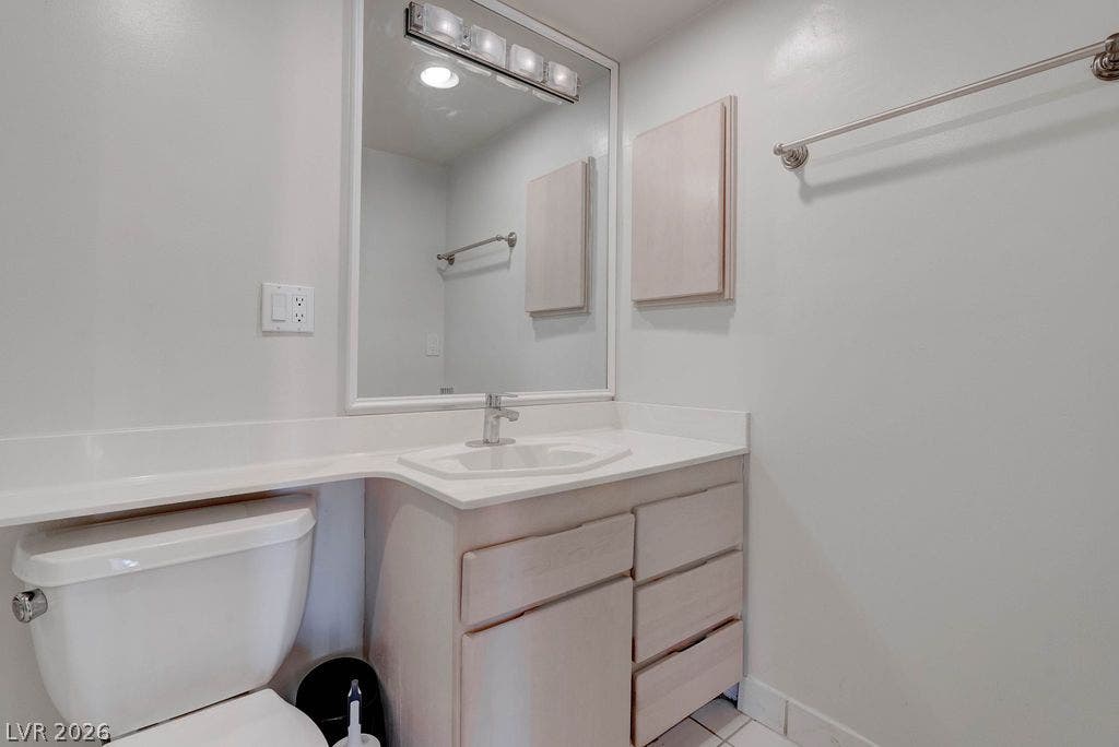 3111 Bel Air Drive, #3A, Las Vegas, NV 89109 An integrated vanity counter and classic tile flooring define this clean bathroom design.