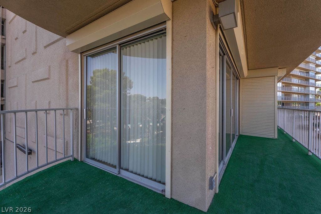 3111 Bel Air Drive, #3A, Las Vegas, NV 89109 Sliding glass doors open onto a spacious private balcony framed by sturdy metal railings.