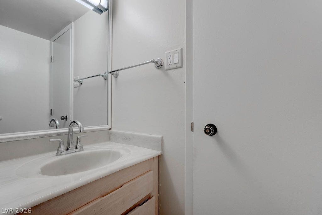 3111 Bel Air Drive, #3A, Las Vegas, NV 89109 An undermount sink with a solid surface countertop anchors this functional vanity area.