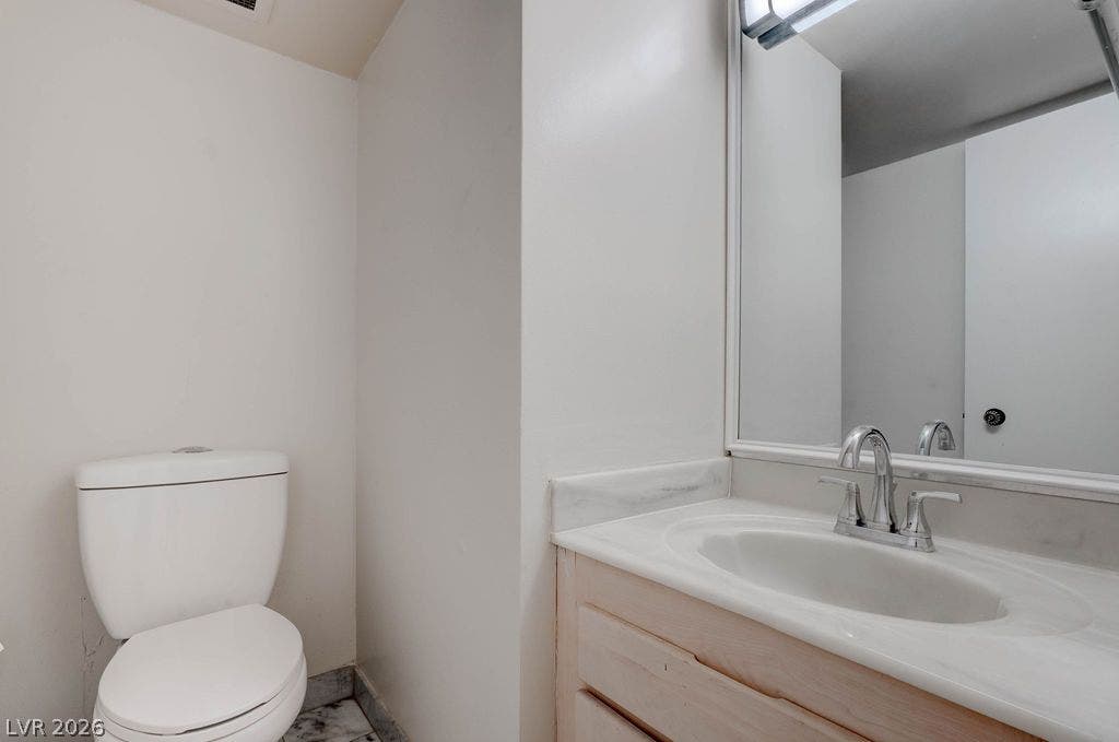 3111 Bel Air Drive, #3A, Las Vegas, NV 89109 Marble tile flooring and a clean vanity with a large mirror highlight this functional powder room.
