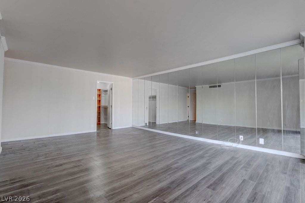 3111 Bel Air Drive, #3A, Las Vegas, NV 89109 Plank flooring and a wall of mirrored closets anchor this open space.