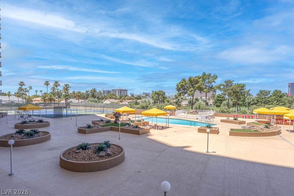3111 Bel Air Drive, #3A, Las Vegas, NV 89109 An expansive outdoor recreation terrace features a swimming pool, tennis courts, and landscaped planters.