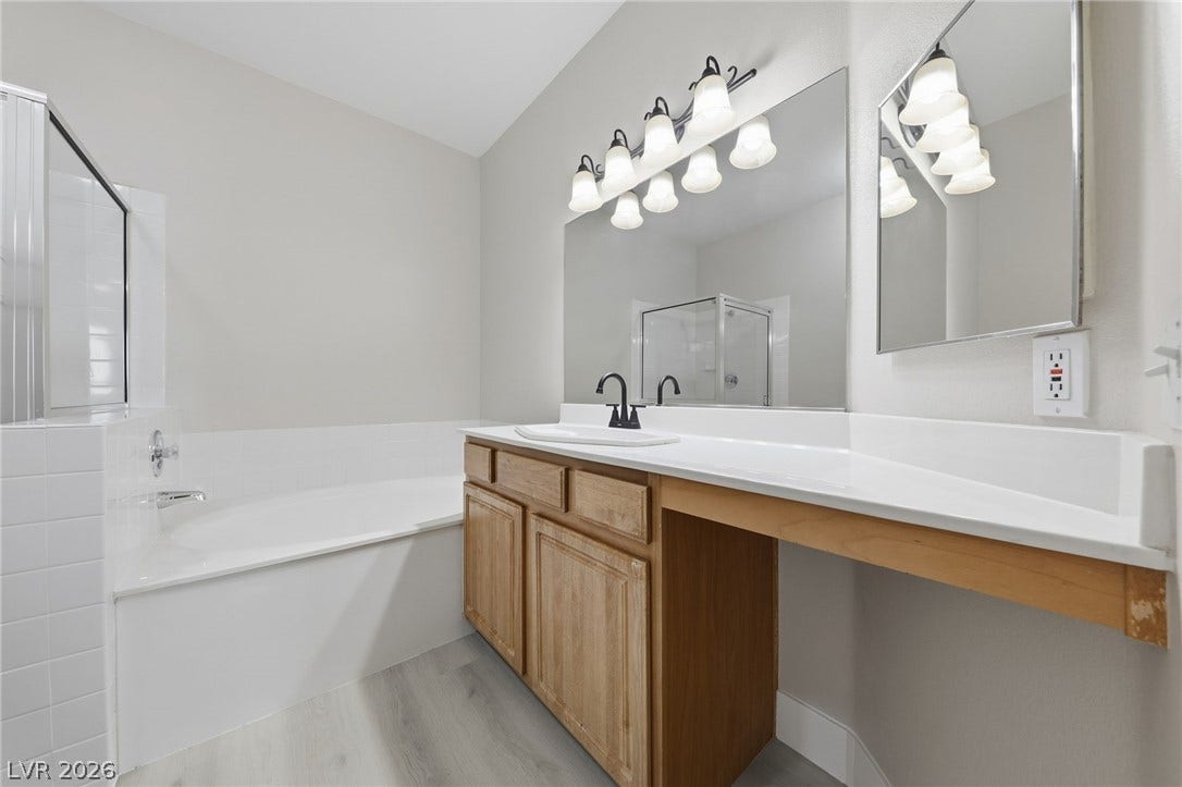 104 Lemon Glaze Street, #204, Las Vegas, NV 89145 Clean lines and a spacious soaking tub highlight this classic, functional bathroom design.